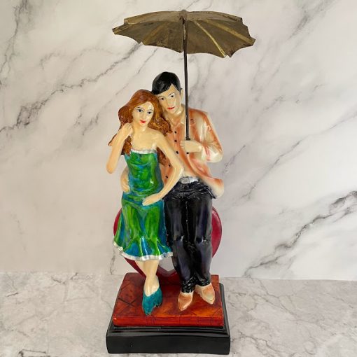 Couple Sitting On Heart Under Umbrella Figurine
