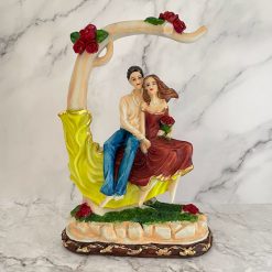 Couple Sitting On Tree Figurine