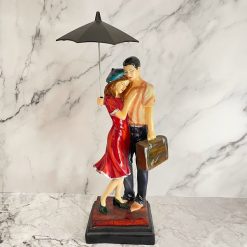 Hugging Couple Under Umbrella Figurine