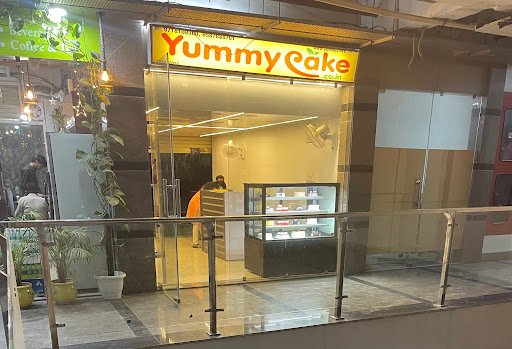 YummyCake outlet lit up in the evening